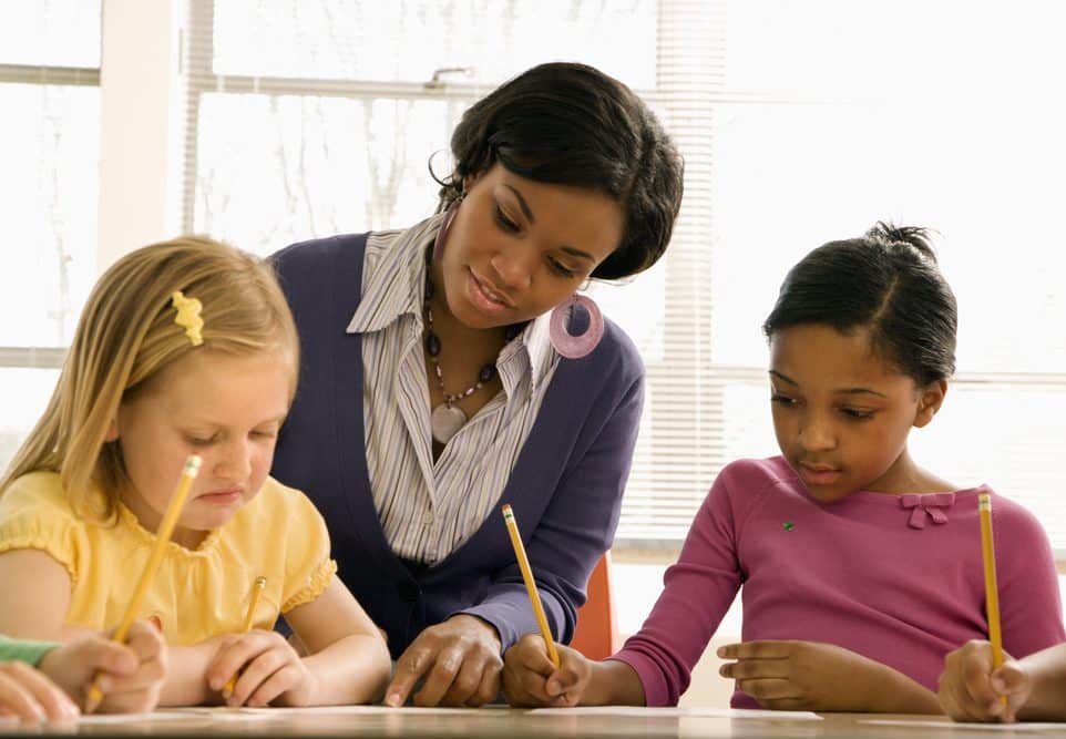 image of Teacher Helping Students With Schoolwork