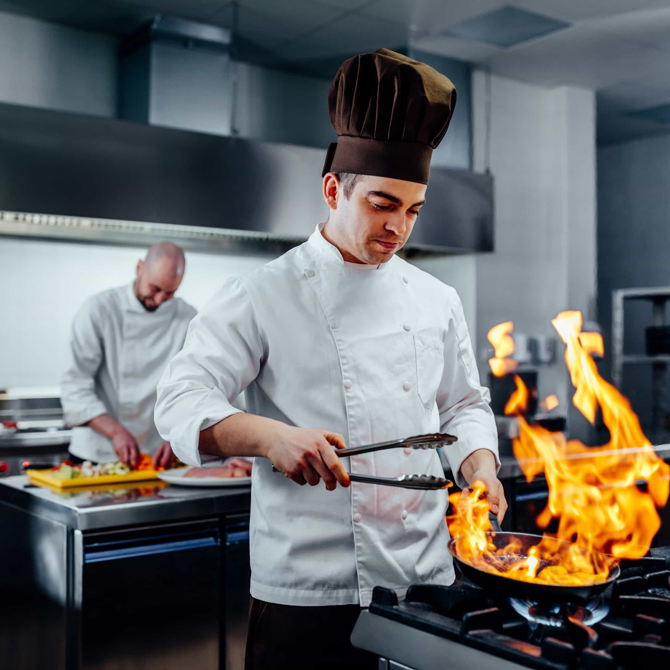 Image of chef with a flaming dish for Fire Hazards A Practical Approach to Workplace Safety blog on Learn Q website