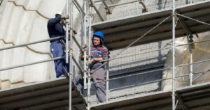 Image of men working on scaffold for Learn Q Working at Height Navigating UK Safety Regulations blog