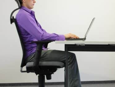 Image of man in office sat correctly for Learn Q Debunking Common UK Health and Safety Myths blog