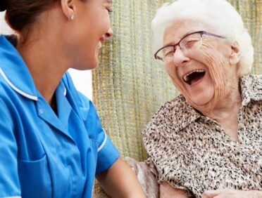 Image of Senior Woman Sitting In Chair And Talking With Nurse for Learn Q Safeguarding Vulnerable Adults in Care Homes blog