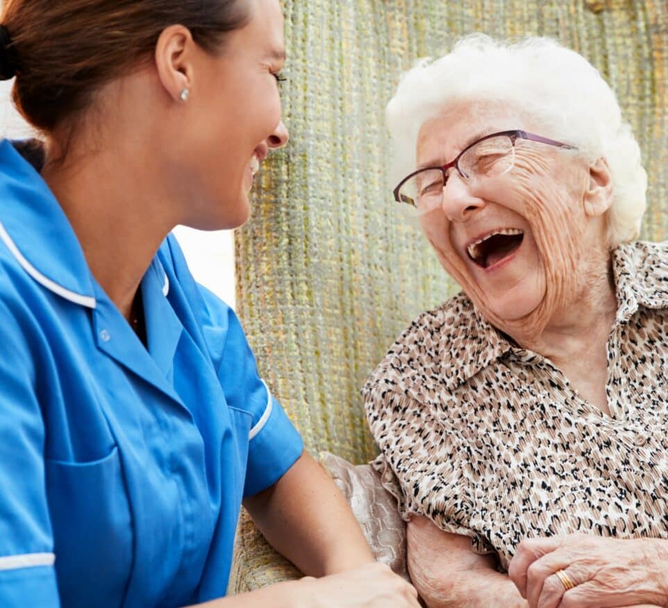 Image of Senior Woman Sitting In Chair And Talking With Nurse for Learn Q Safeguarding Vulnerable Adults in Care Homes blog