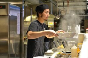 Image of man serving ramen for Learn Q Ten Key Benefits of Food Hygiene and Safety blog