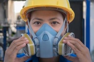 Image of Lady in Safety Mask for Learn Q Asbestos Safety Role of Occupational Health Safety Professionals blog