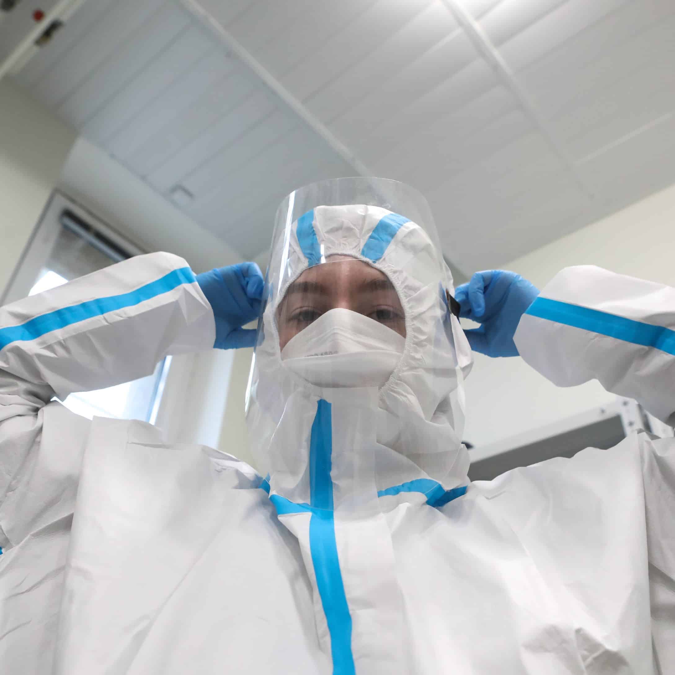 Image of Man Putting on Asbestos Suit for Learn Q Asbestos Safety Role of Occupational Health Safety Professionals blog