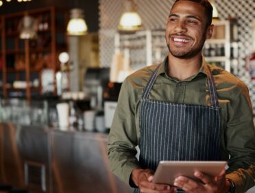 Image of waiter with tablet containing data for Learn Q GDPR Employees' Roles and Responsibilities blog