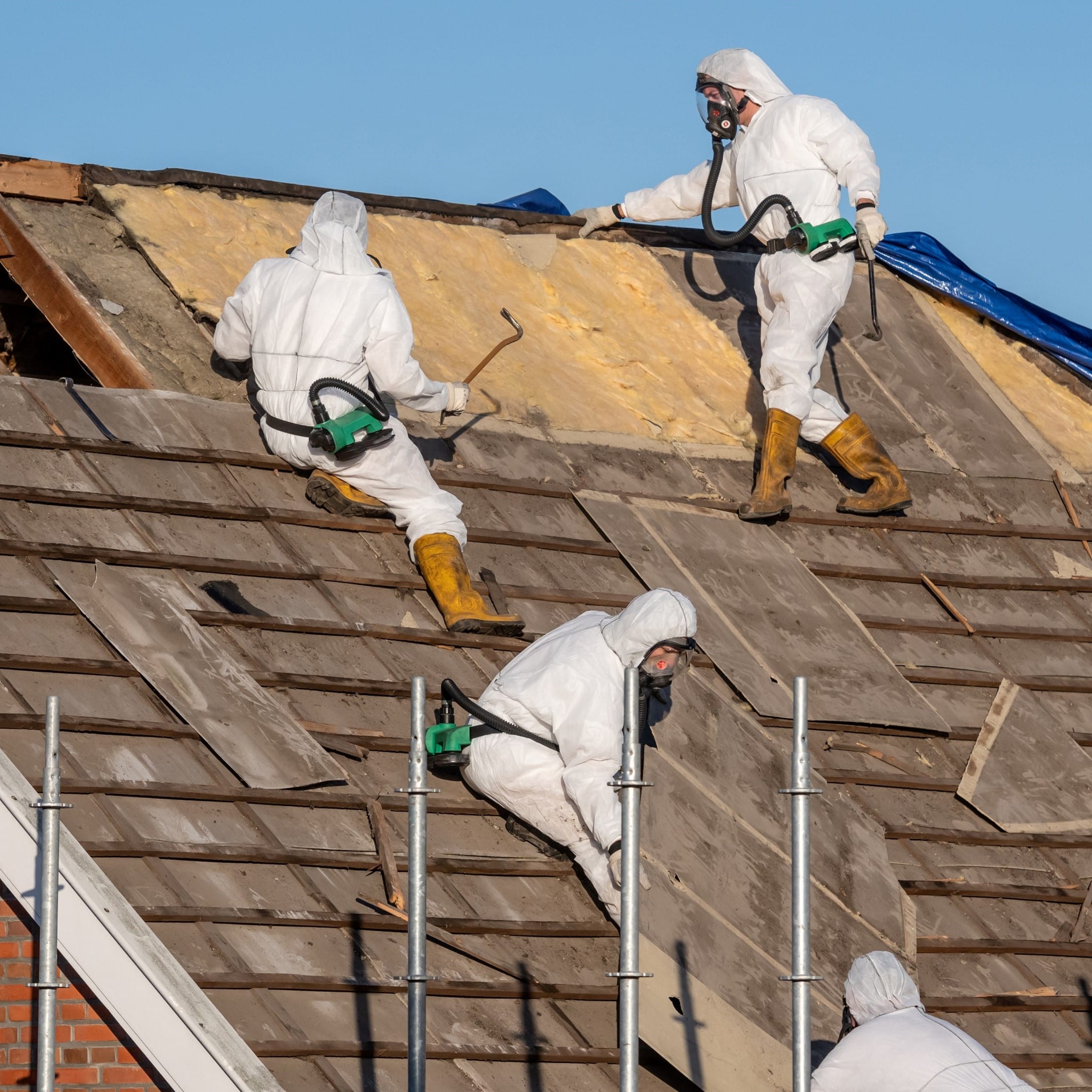 Image of men removing asbestos from a roof for Learn Q Asbestos Safety Responsibilities of Regulatory Agencies blog