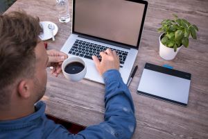 Image of Home Worker Working at his Desk for Learn Q Health and Safety Home Working blog