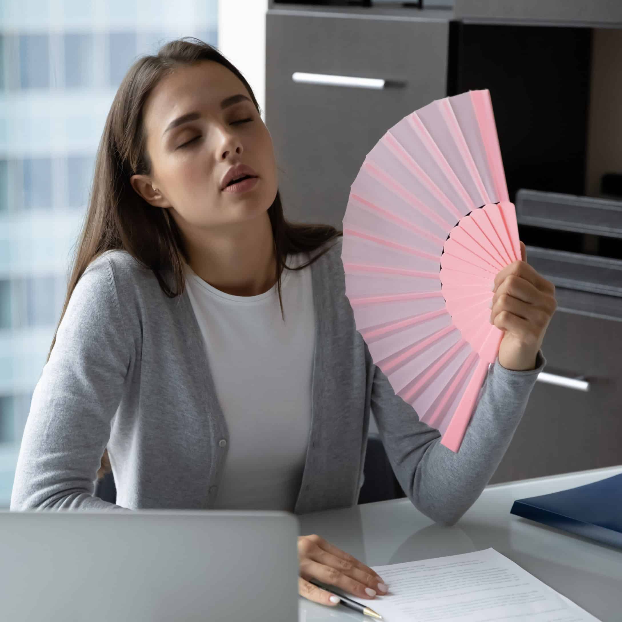 Image of Female Worker Finding the Workplace Hot for Learn Q Health and Safety Temperature at Work blog